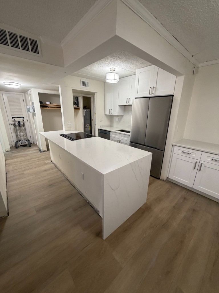 Modern kitchen remodel with white quartz waterfall island and Shaker cabinets